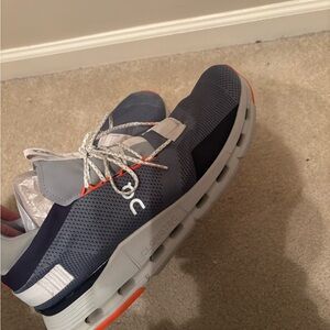On Running Sneakers with Gray and Orange Accents